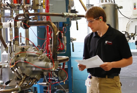 Intern learning about a machine part