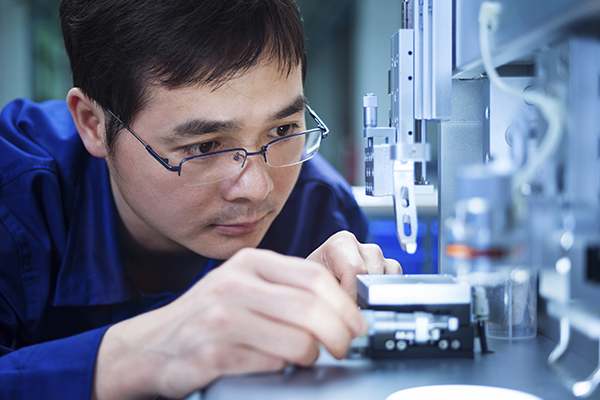 Man examining a machine part